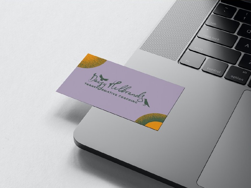 The lilac card with her logo lying on an open laptop