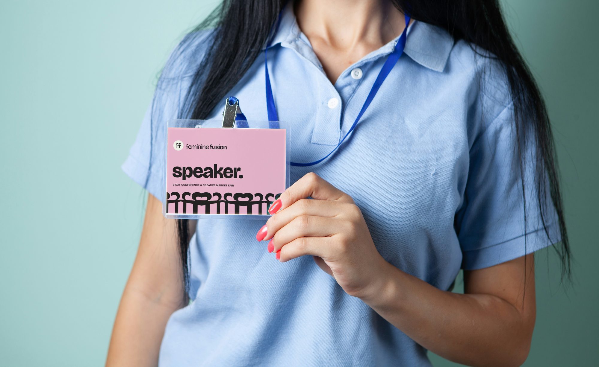 A speaker's badge worn on a lanyard: speaker. in black on pink, the logo above, the row of figures along the bottom of the card