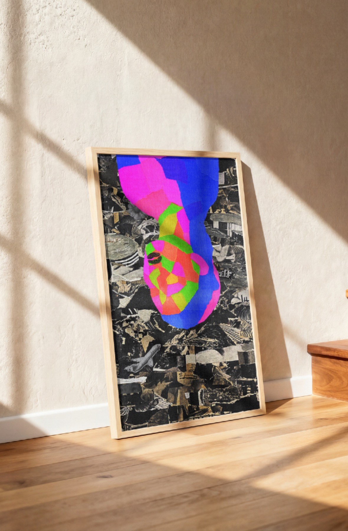 The collage framed, leaning on a wall in the sun