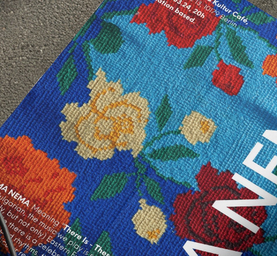 Close-up of a 2023 poster: cross-stitch roses on blue, the name running through them